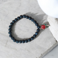 Onxy beaded bracelet with red flower charm