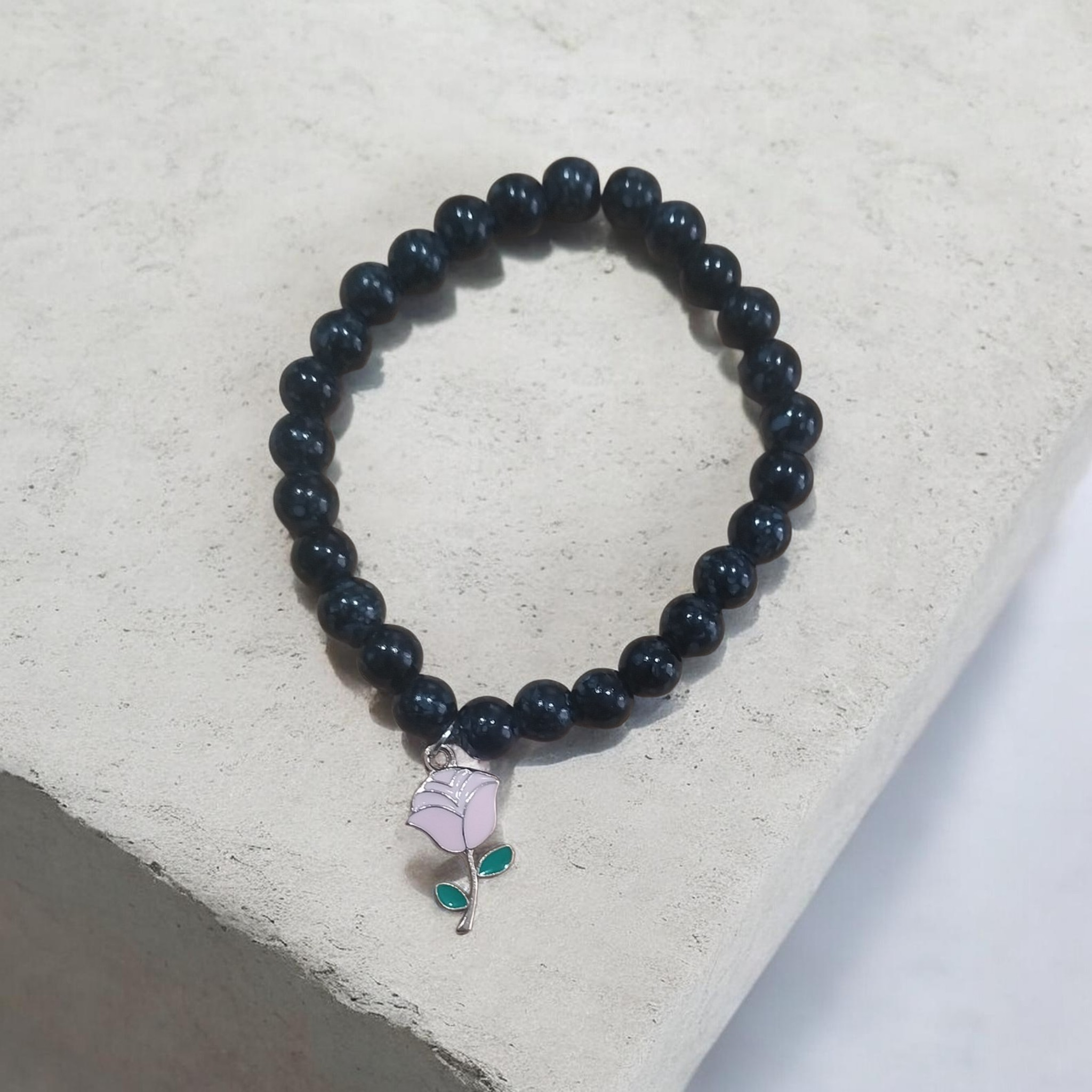 Onxy beaded bracelet with pink flower charm